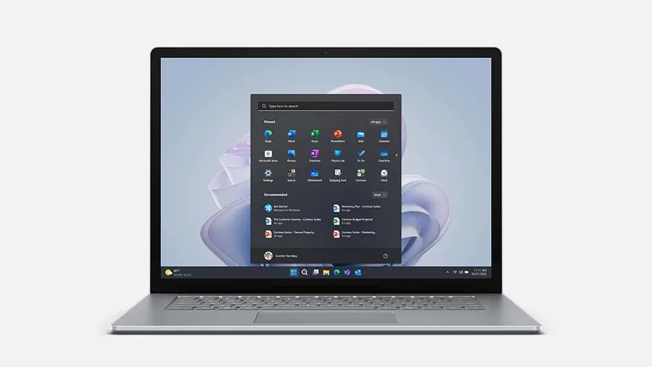 Een laptop met een Windows-startmenu overlay, tegen een effen witte achtergrond. Het scherm toont diverse app-icoontjes.