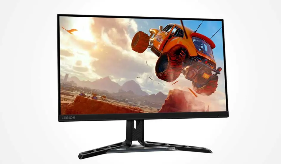 Lenovo Legion gamemonitor toont een feloranje offroadwagen die hoog door de lucht vliegt boven een stoffig woestijnlandschap.