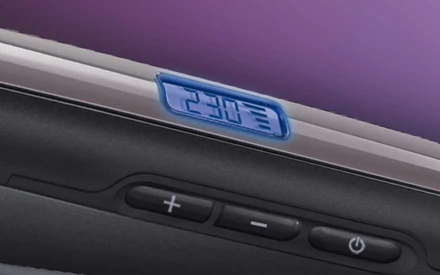 Close-up of a straightener’s control buttons and digital display, showing a temperature setting of 230 degrees.