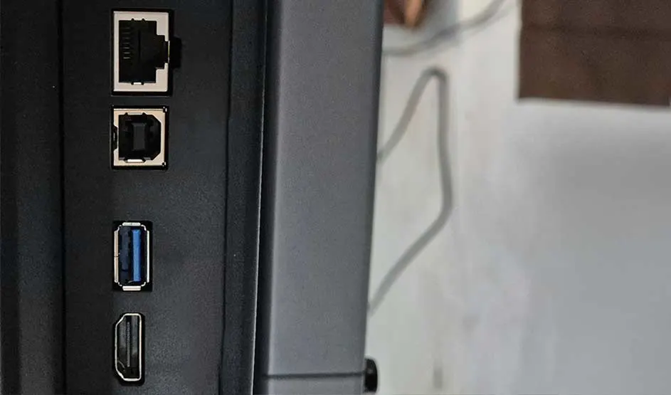 A close-up shows ports on a device: network sockets, USB and HDMI along the side.