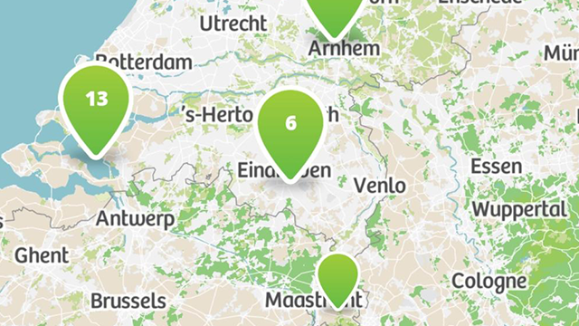 Kaart van Nederland en delen van België en Duitsland met groene locatiemarkeringen en plaatsnamen.