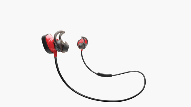 Twee rode en zwarte oordopjes verbonden door een zwarte draad liggen op een witte achtergrond.
