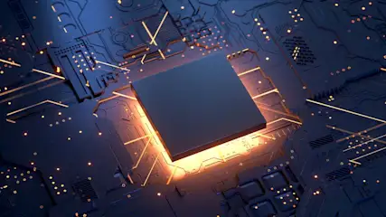 Een close-up van een vierkante, donkergrijze microchip op een blauw circuitbord met gele lichtlijnen en kleine, ronde componenten.