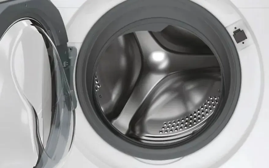 The image shows the open drum of a modern front-loading washing machine. No brand name is visible on the appliance.