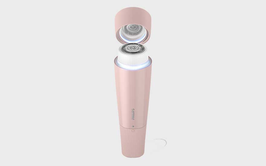 A stylish pink Philips facial cleansing brush with its cap open is displayed against a plain background.