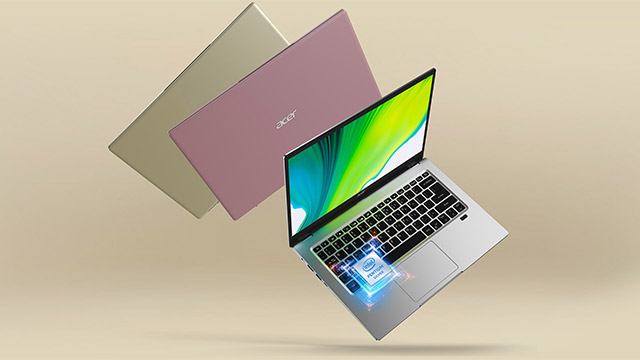 Ein geöffneter, silberner Laptop mit grünem Bildschirm, flankiert von zwei geschlossenen Laptops in Gold und Lila.