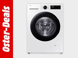 Bild mit grauem Hintergrund. Links davon steht "Oster-Deals" in weißer Schrift vor rotem Hintergrund. Rechts davon eine Waschmaschine