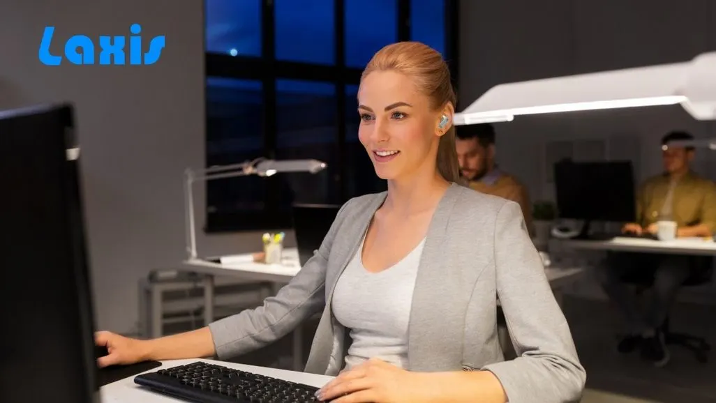 Computeranimierte Darstellung einer weiblichen Person am Computer in einem Büro - im Hintergrund ein Laxis Logo.