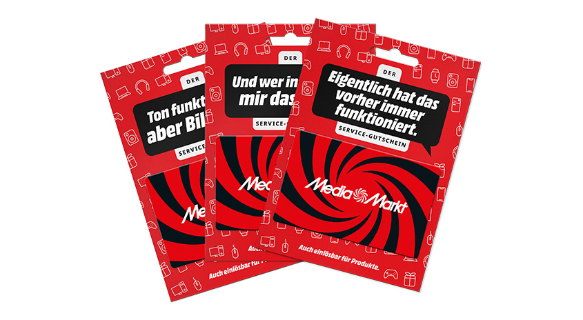 Ein Fächer aus drei MediaMarkt Gutscheinkarten.
