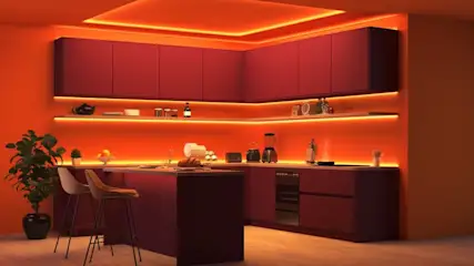 Eine Küche wird durch indirekte Philips Hue-Beleuchtung in orange-rotes Licht getaucht.