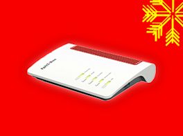 W-LAN Router auf rotem Hintergrund, dekoriert mit gelber Schneeflocke in der Ecke.