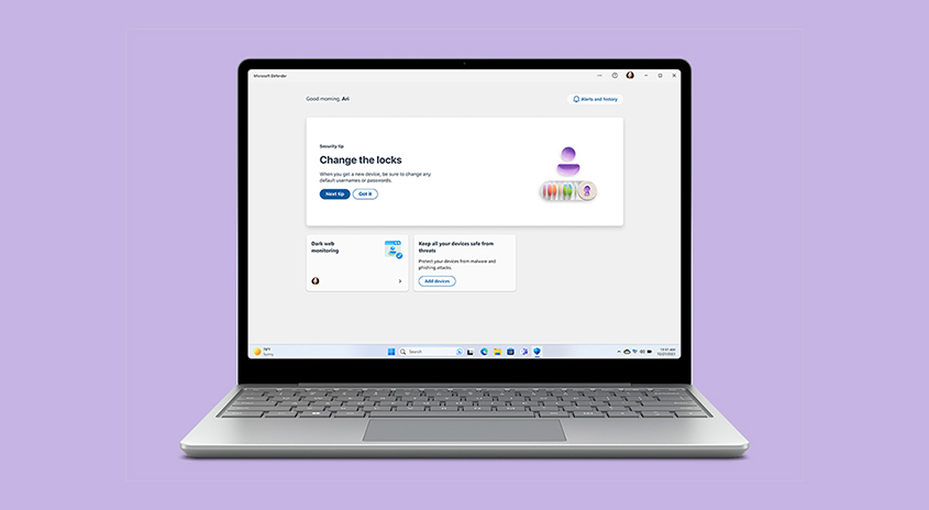 Ein silberner Laptop zeigt eine Microsoft Defender-Sicherheitswarnung vor einem violetten Hintergrund. Auf dem Bildschirm sind Sicherheitsoptionen zu sehen.