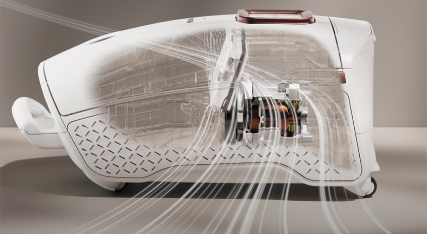 Ein weißer Staubsauger mit transparenten Abschnitten, der die inneren Mechanismen und Luftströme zeigt, steht auf einem grauen Untergrund.