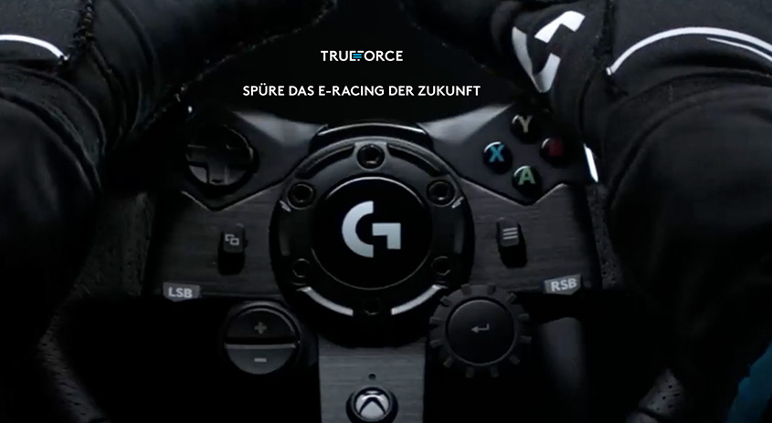 Nahaufnahme eines schwarzen Lenkrads mit dem 'G'-Logo in der Mitte, umgeben von Knöpfen und Bedienelementen.