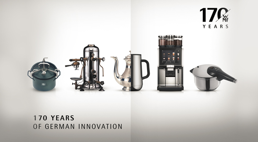 Eine Reihe von Küchengeräten, von Kochtöpfen bis hin zu Kaffeemaschinen, vor einem hellen Hintergrund.