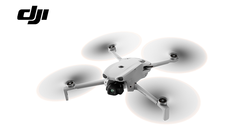 Ein weißer DJI Mini 3 Pro Drohne mit Kamera und Propellern.