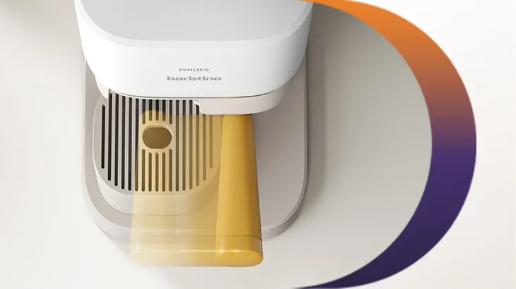 Detailansicht einer Philips Baristina Kaffeemaschine von oben mit gelbem Siebträger und Abtropfgitter in modernem, hellen Design.
