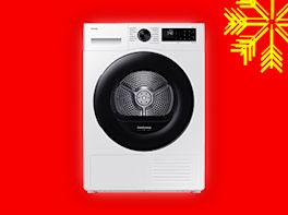 Waschmaschine auf rotem Hintergrund, dekoriert mit gelber Schneeflocke in der Ecke.