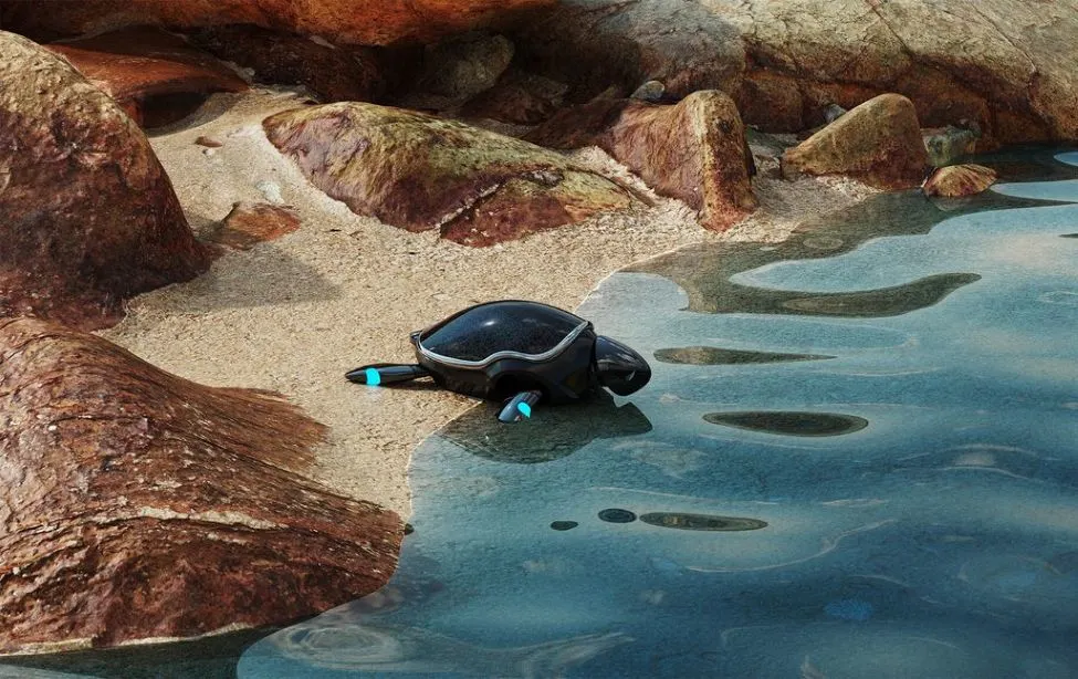 Roboterschildkroete am Ufer zwischen Felsen und Wasser