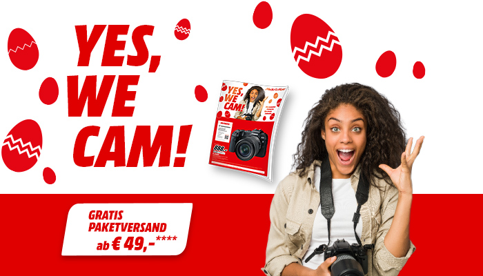 Roter Text "YES, WE CAM!" mit roten Ostereiern auf Weiß. Eine Zeitschrift und eine Kamera sind abgebildet. Unten steht "GRATIS PAKETVERSAND ab € 49,-".