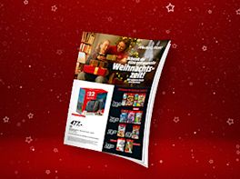 Die 3D Ansicht des aktuellen MediaMarkt Prospektes vor rot-weihnachtlichem Hintergrund.