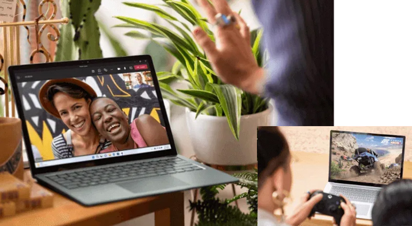 Ein Laptop zeigt ein Video von zwei Frauen. Eine Person winkt, während eine andere Person auf einem anderen Laptop spielt.