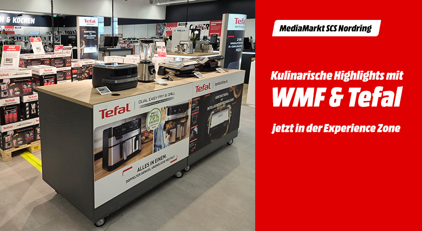 In einem Laden steht ein Tisch mit Küchengeräten der Marke Tefal. Im Hintergrund sind weitere Produkte und Regale zu sehen.