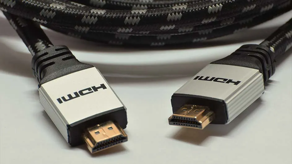 Deux câbles HDMI avec des connecteurs dorés reposent sur une surface claire, avec un câble tressé noir et gris.