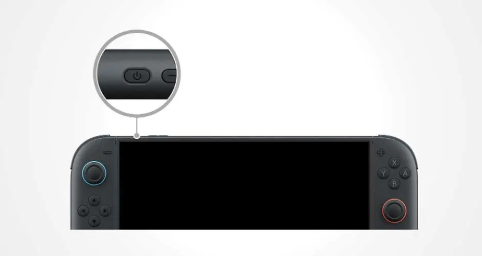 Close-up van een zwarte handheldconsole met focus op de aan/uit-knop bovenop, weergegeven door een vergrootglas.