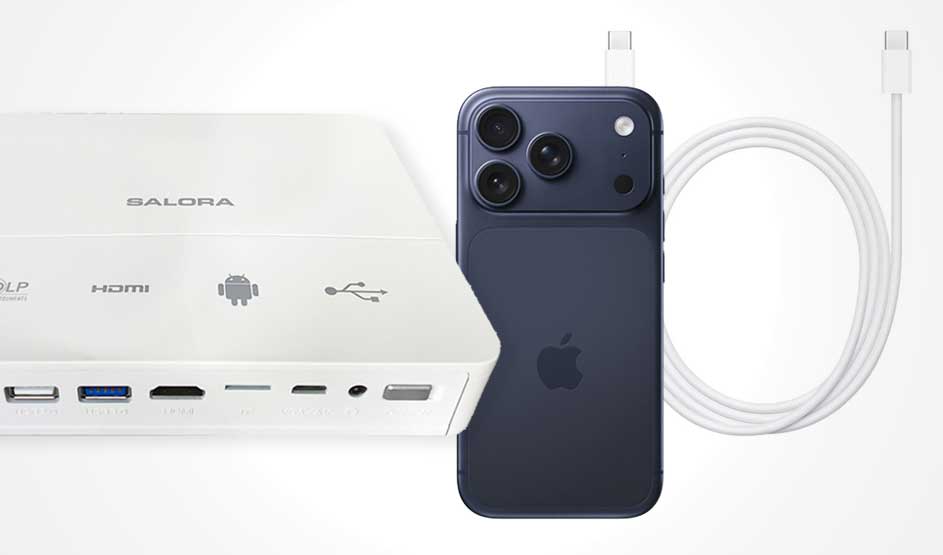 Projecteur ou adaptateur blanc à côté d’un iPhone sombre, avec un câble et des ports visibles pour vidéo, USB et alimentation.