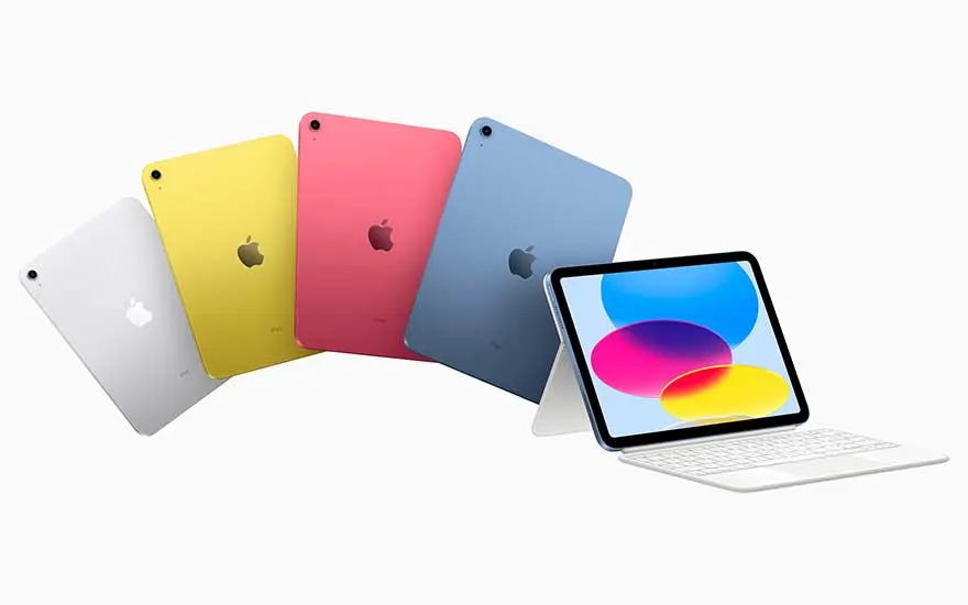 Cinq iPad argenté, jaune, rose et bleu s’éventailent sur fond blanc ; l’un est posé avec clavier et écran très coloré, bien éclairé.