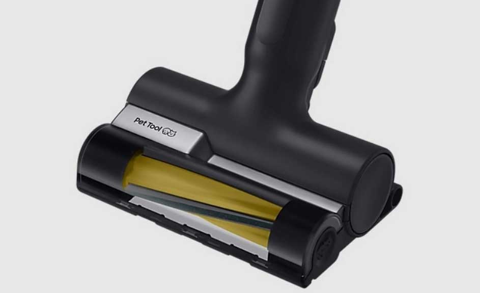 Een zwarte stofzuigerborstel met gele roterende borstel en zilverkleurige 'Pet Tool' aanduiding tegen een grijze achtergrond.