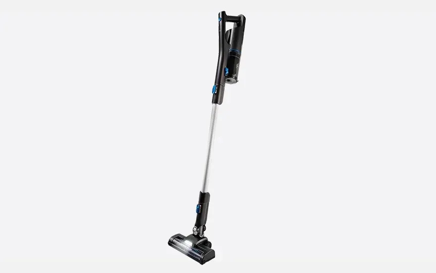 Slim cordless stick vacuum with black handle and silver tube, standing upright against a light background, ready to clean floors efficiently.