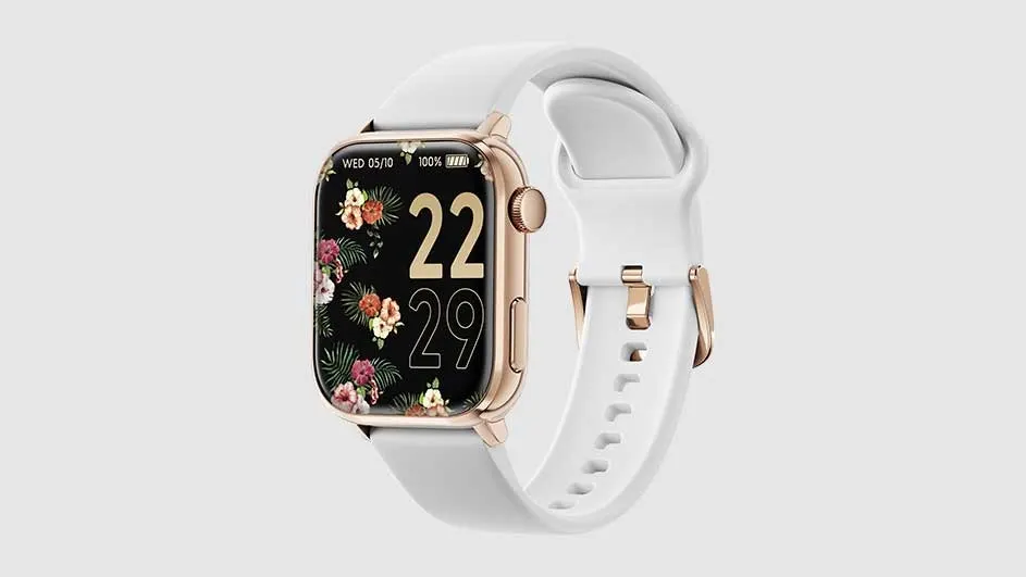 Smartwatch with a white band. The watch face is black with flowers and the time 22:29. The watch casing is gold.