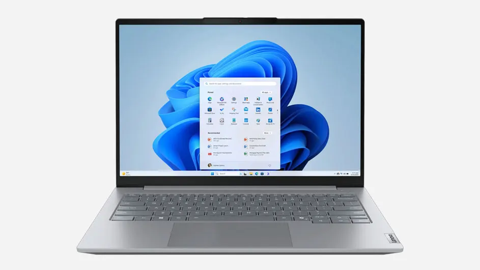 Ordinateur portable Lenovo argenté avec écran d'accueil Windows, affichant un fond bleu avec diverses icônes d'applications visibles.