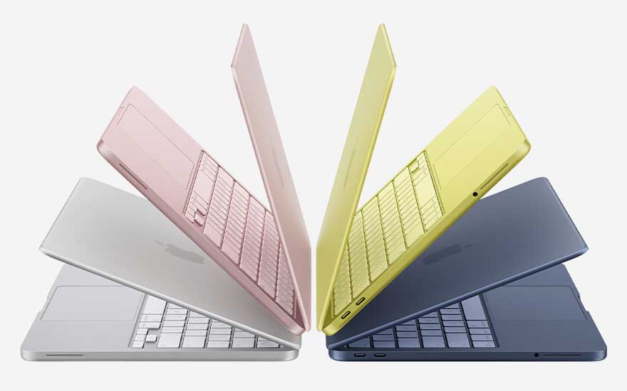 Quatre MacBook semi ouverts argent, rose, jaune et bleu forment un éventail, mettant en valeur leur design fin et leurs couleurs vives.