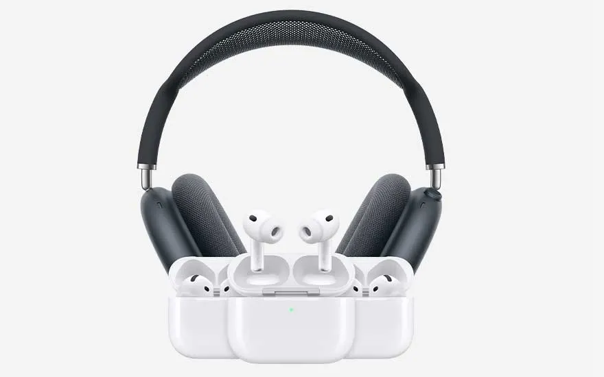 A sleek over ear headset stands behind several pairs of white wireless earbuds in open charging cases, arranged neatly on a light background.