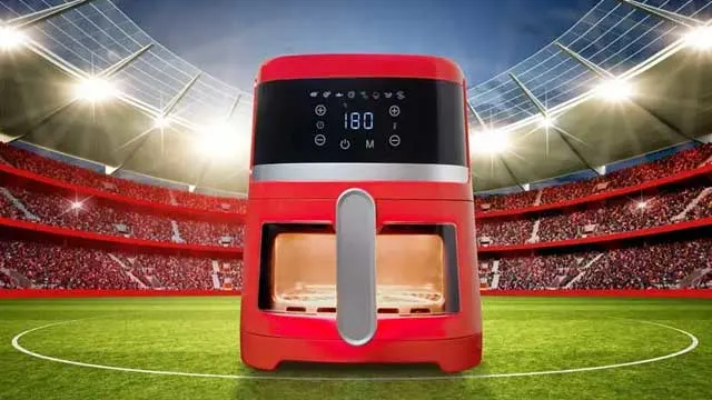 Friteuse rouge sur terrain vert, stade en arrière-plan. L'écran affiche "180".