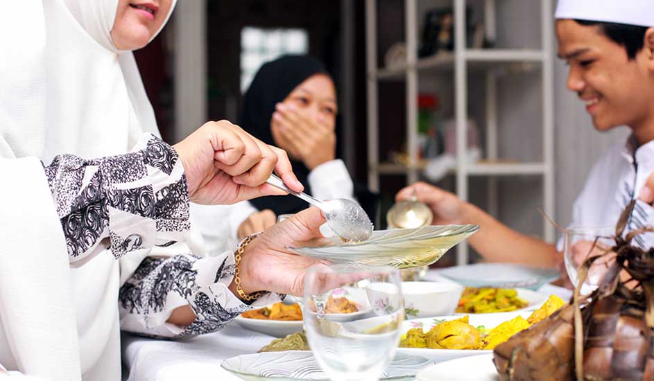 Een tafel gedekt met diverse gerechten, waaronder rijst en groenten, klaar voor een maaltijd.