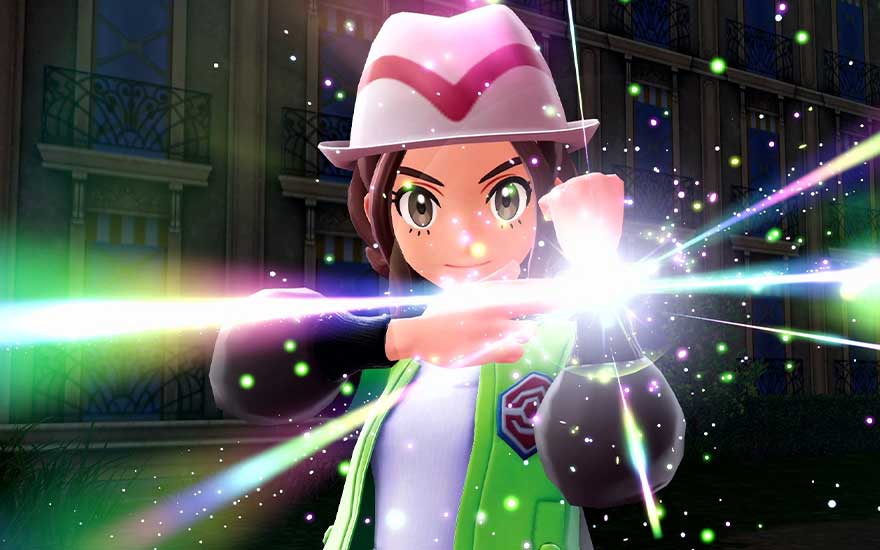 Gros plan d'un dresseur effectuant un geste, entouré de faisceaux lumineux colorés, avec un regard déterminé et concentré.