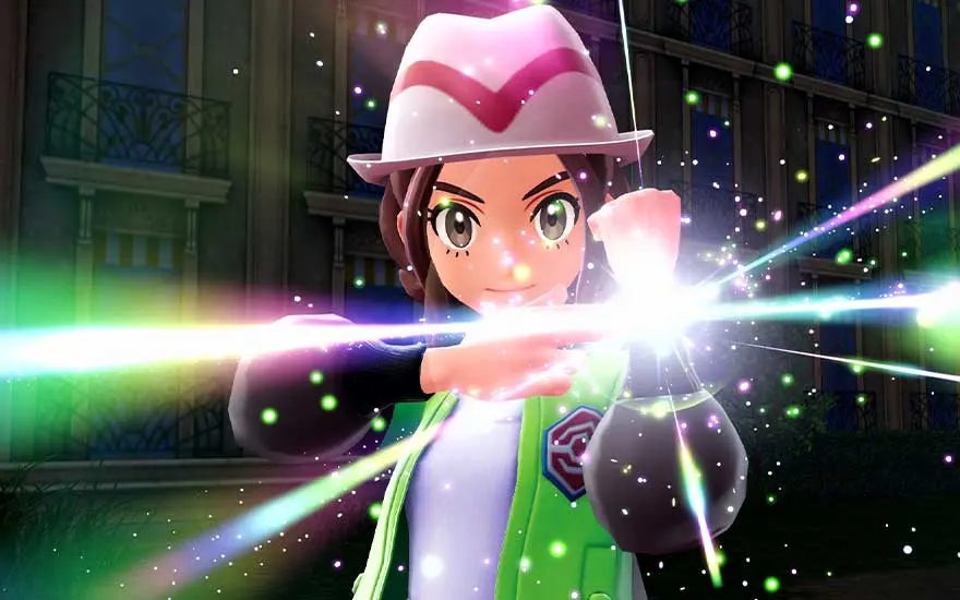 Gros plan d'un dresseur effectuant un geste, entouré de faisceaux lumineux colorés, avec un regard déterminé et concentré.