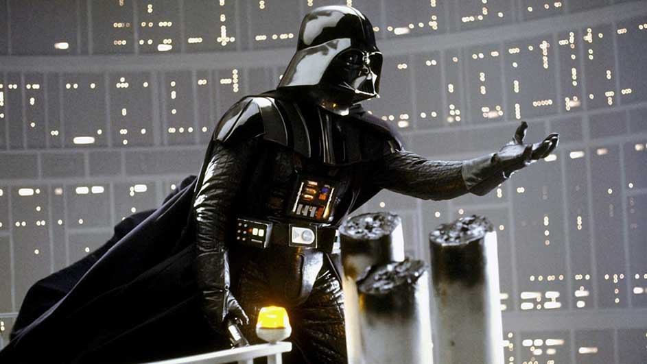 Un personnage en costume noir avec un casque se tient devant une fenêtre avec des lumières.