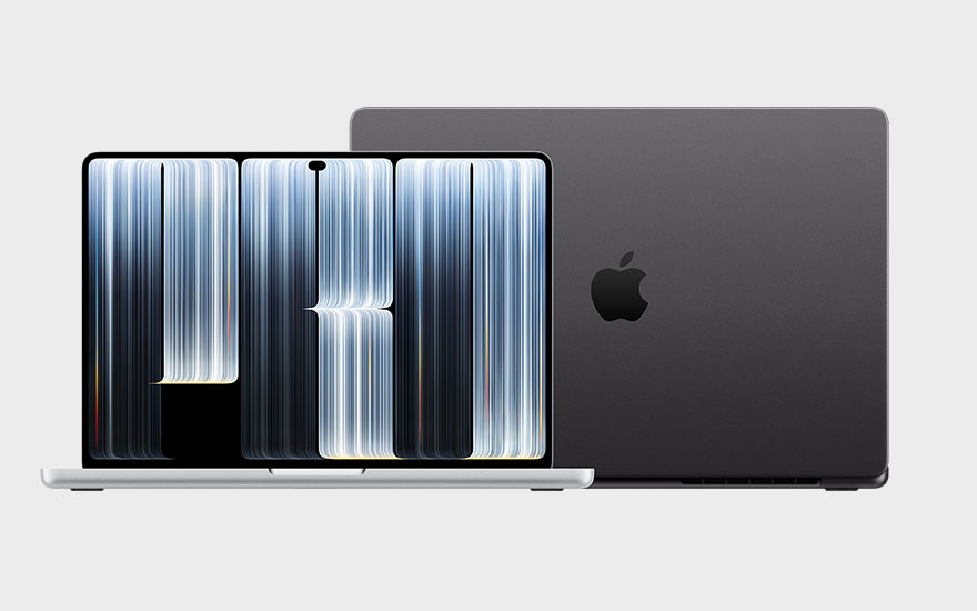 A dark Apple Macbook Pro laptop is open in front of a second one. Its screen displays abstract blue and white light streaks against a black background.