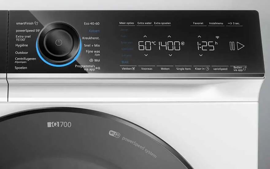 Gros plan d'un lave-linge blanc avec un panneau de commande noir affichant les réglages de température, d'essorage et de temps.