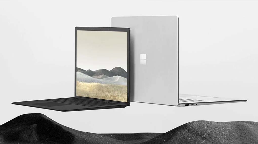 Deux ordinateurs portables Microsoft Surface sur fond blanc. L'un est noir, l'autre gris argenté.