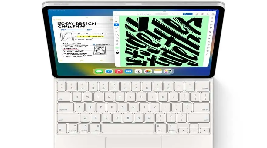 Tablette avec clavier blanc. L'écran affiche des applications avec texte et graphiques.