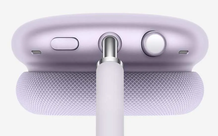 Detailed close-up of a lilac headphone reveals cushioned ear pad, metal stem and top section with button, microphone slot and tactile crown.