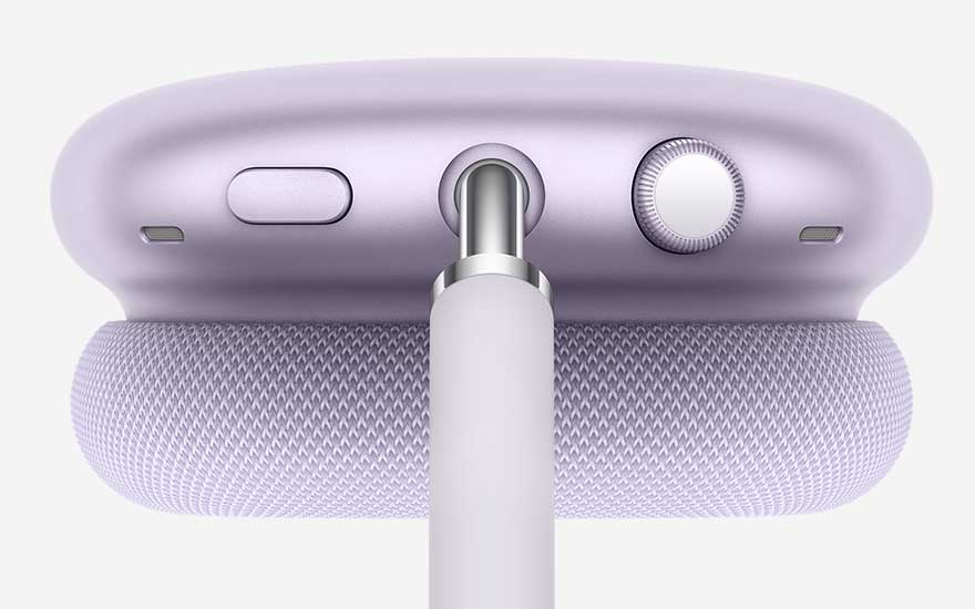 Detailopname van een lila hoofdtelefoon toont kussen, metalen staaf en bovenkant met knop, microfoorgleuf en kroon, allemaal scherp uitgelicht.