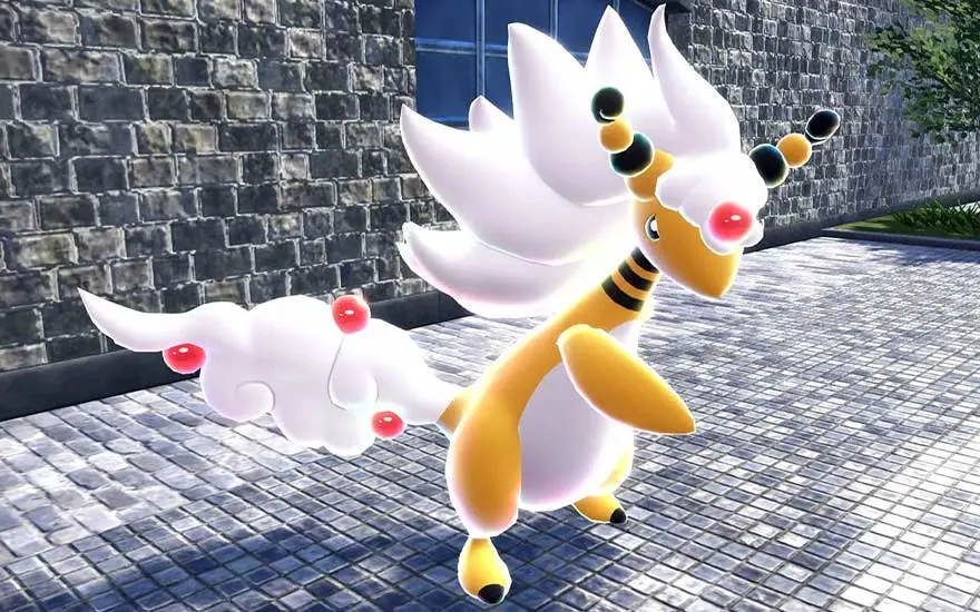 Mega Ampharos stands on a paved path near a stone wall, its white mane flowing with red orbs, glowing in the sunlight.