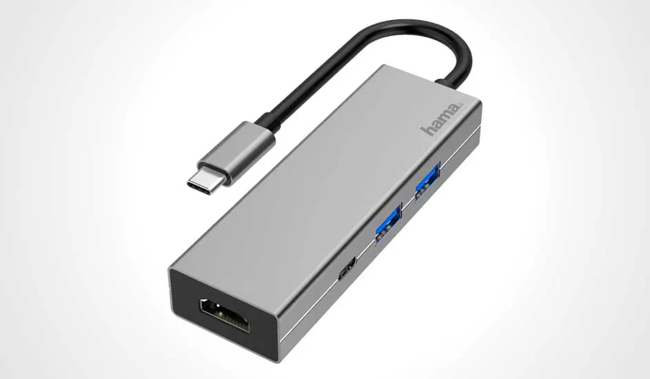 Grijze Hama USB-C hub met zwarte kabel en USB-poorten, liggend op een witte achtergrond.